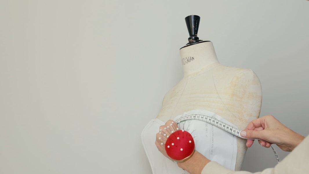 A pattern being fitted on a dress form in the Ancient Kallos atelier